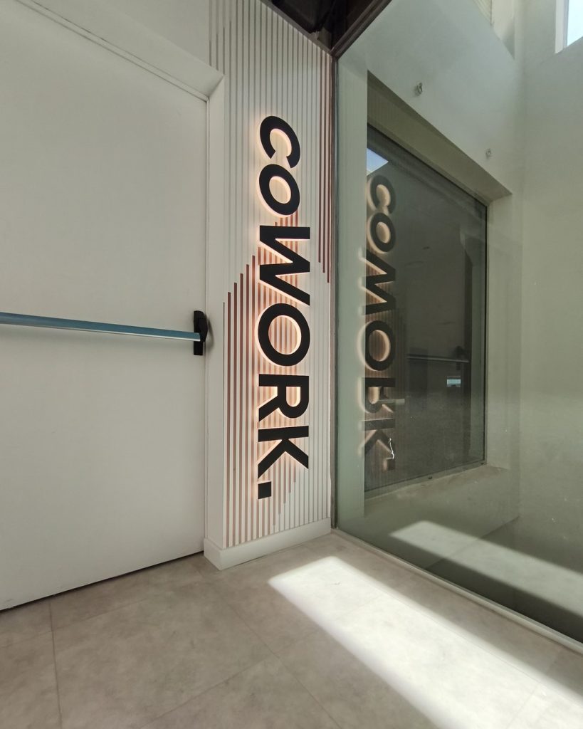 Letras corpóreas de metacrilato retroiluminadas con la palabra COWORK en Sky Business Center, Manises